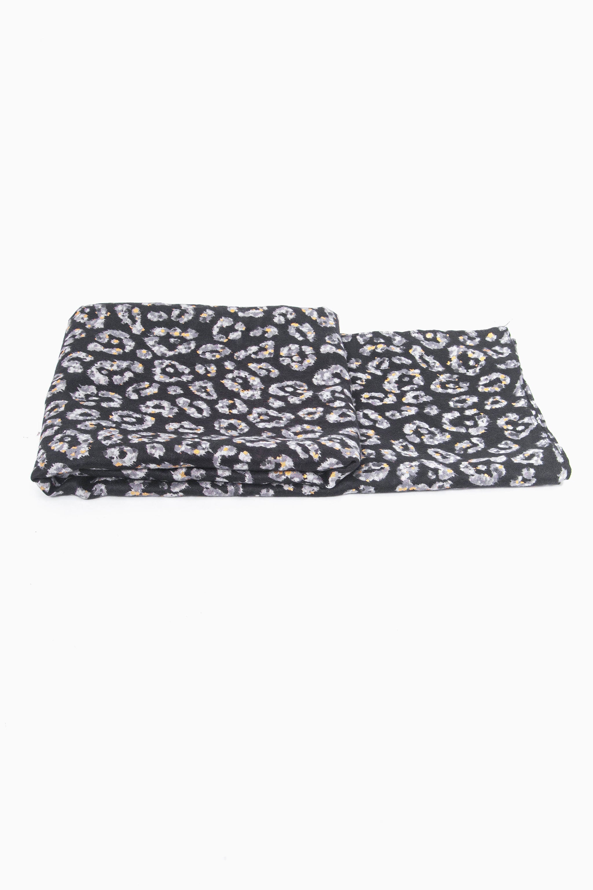 side view of the scarf when folded, showing the texture and thickness of the material. this scarf is lightweight