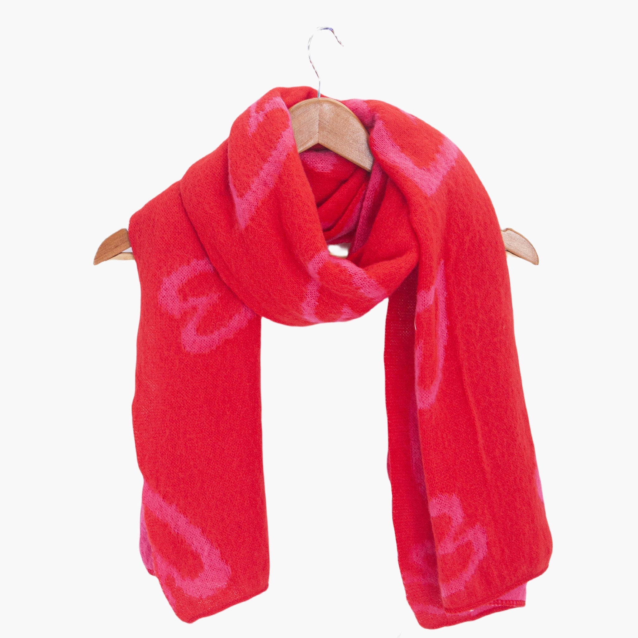 zuri-red-pink-sketched-hearts-heavyweight-scarf-draped-on-coat-hanger