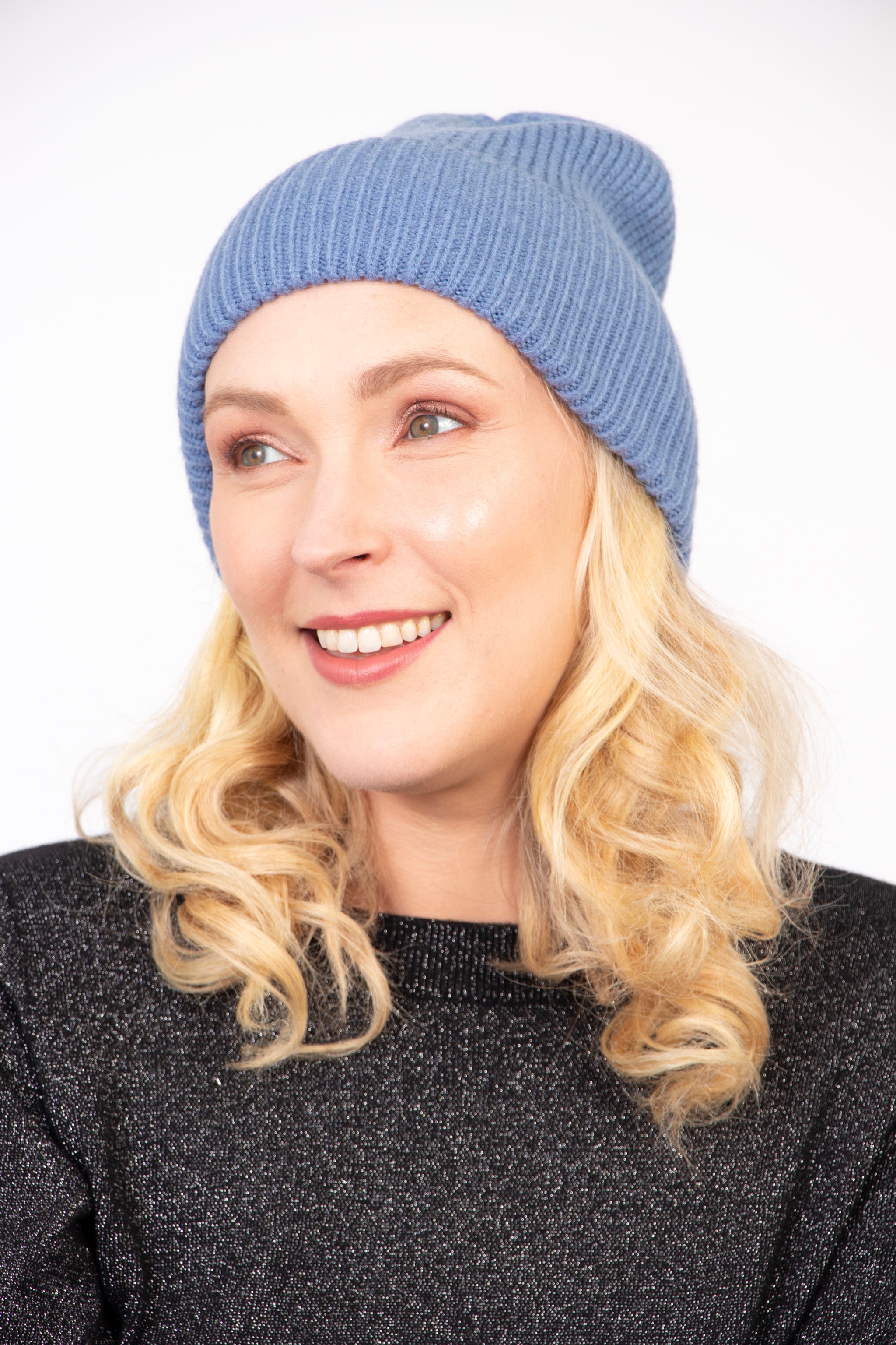 model wearing a light denim blue winter beanie hat