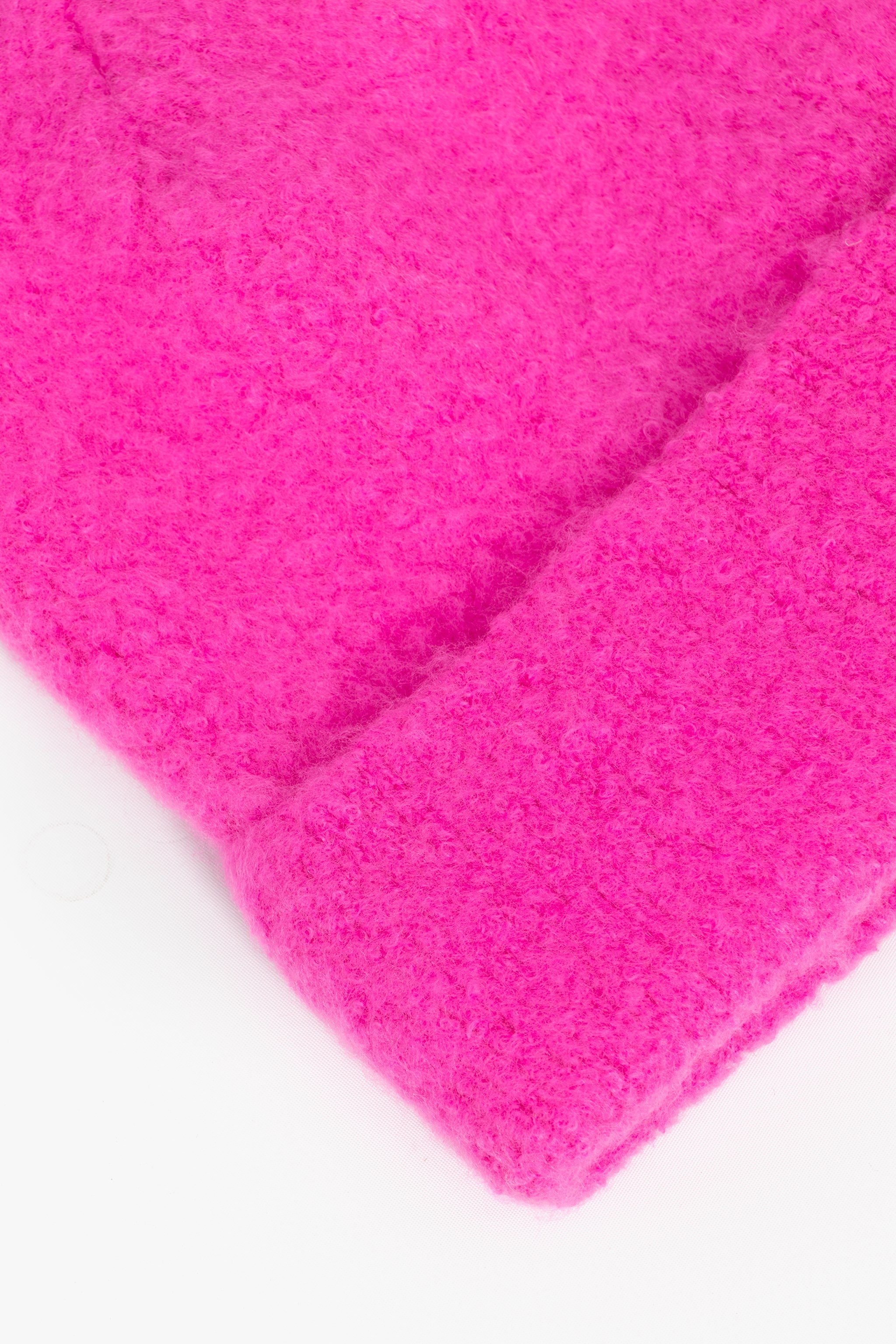 close up of the fluffy textured knitted fabric of the beanie hat.