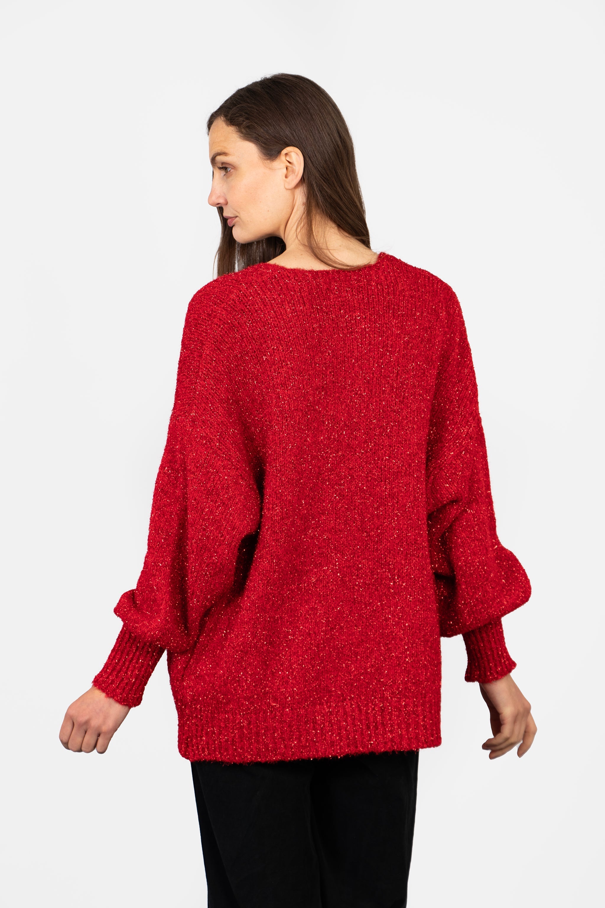 model showing the back of the red sparkly cardigan showing the all over sparkly effect