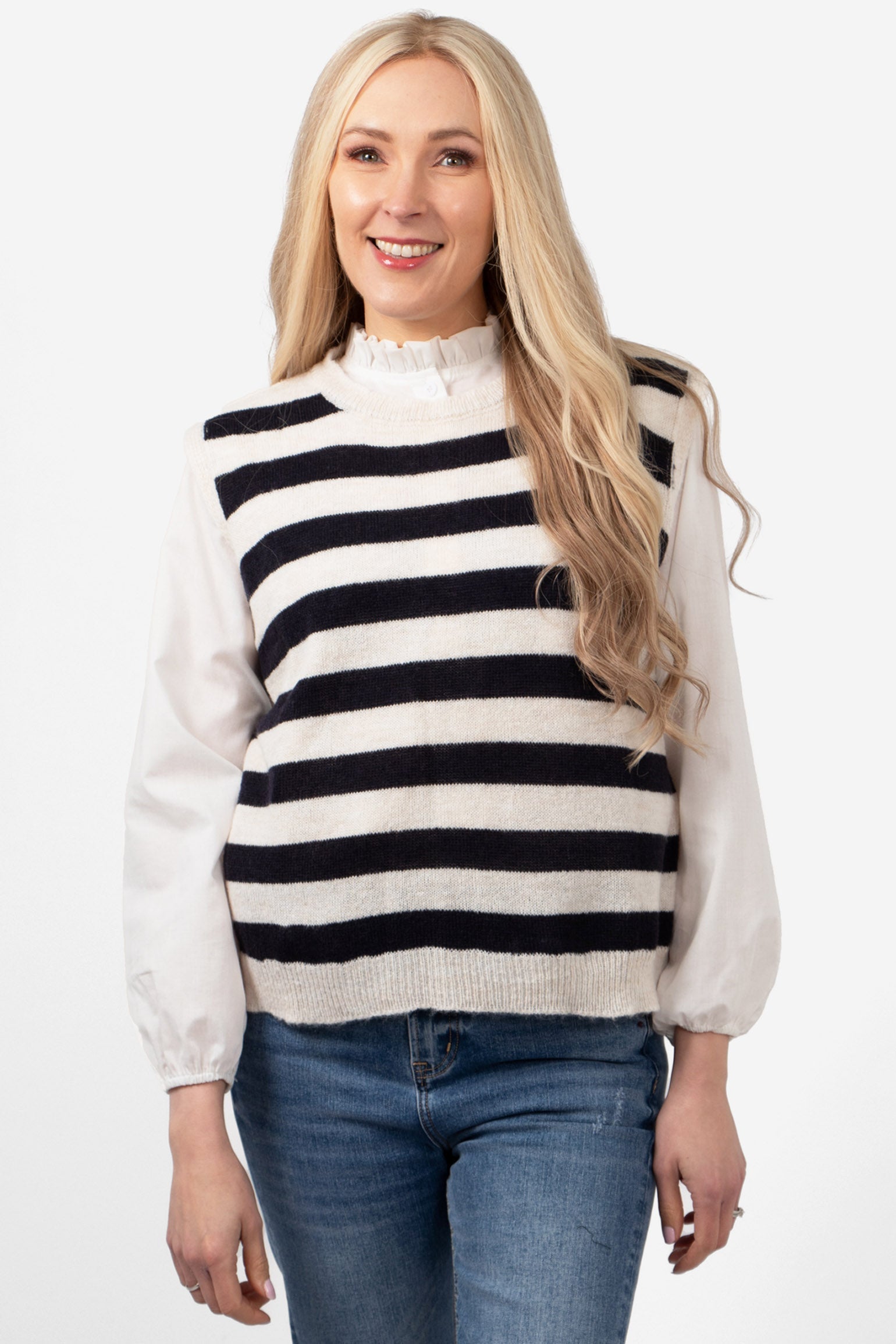 model wearing a cream and navy blue striped knitted tank too. the knitwear is sleeveless and has a round neck