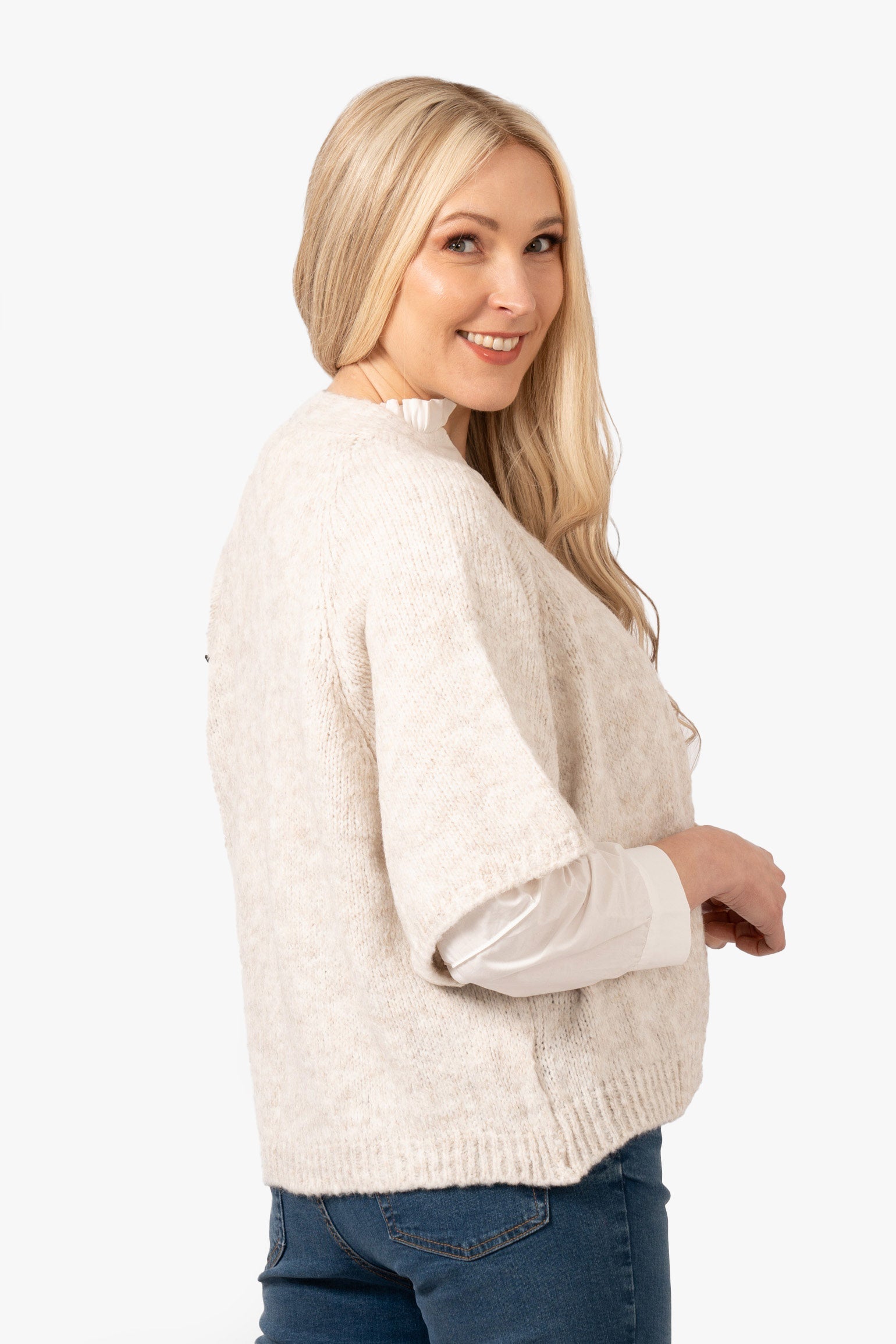 amelia-short-sleeve-wool-blend-cardigan-cream-model-showing-the-side-the-piece-has-loose-fitting-short-sleeves