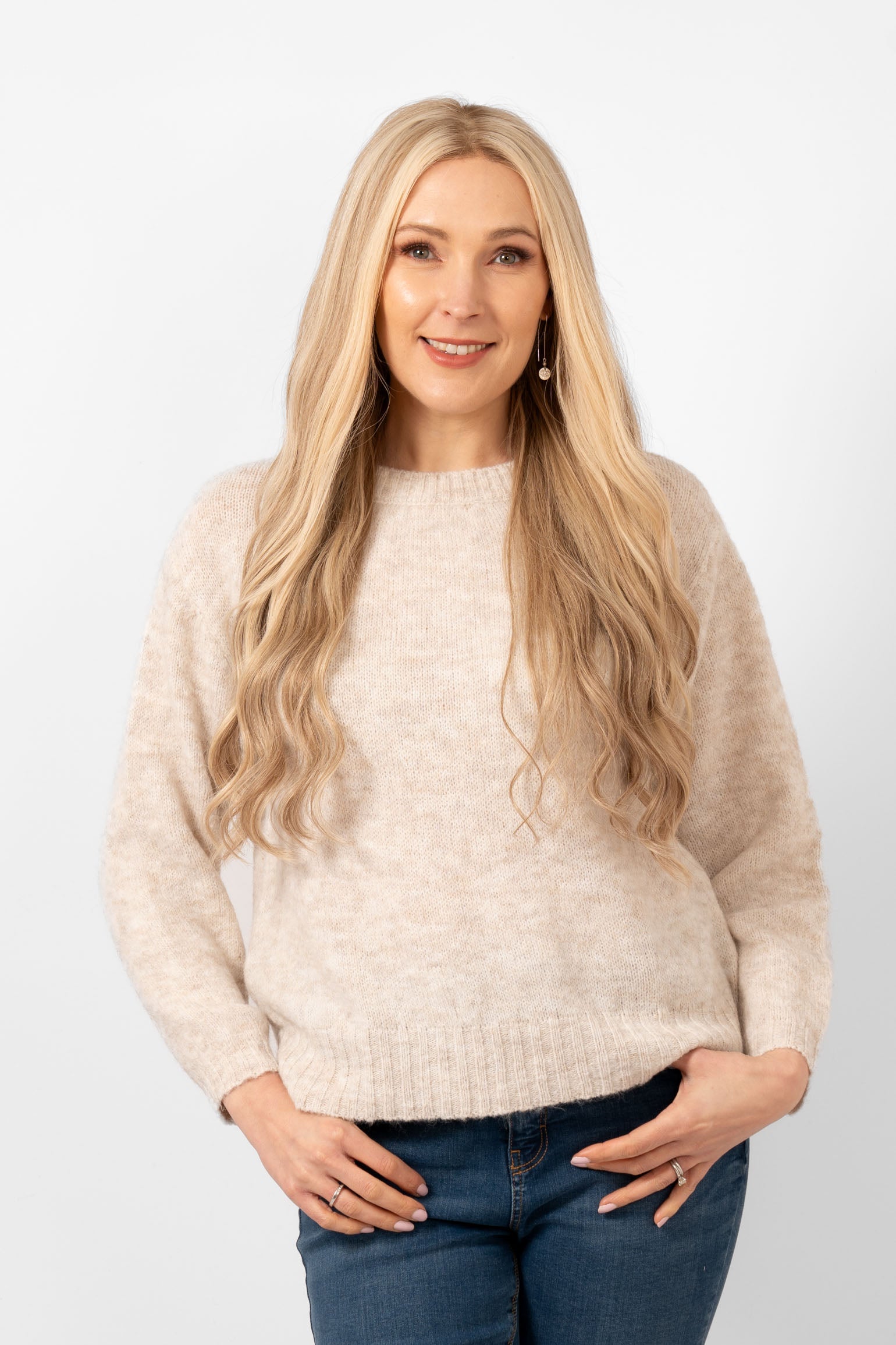 paige-wool-blend-round-neck-jumper-cream-model-wearing-jumper-paired-with-blue-jeans-showing-front-view