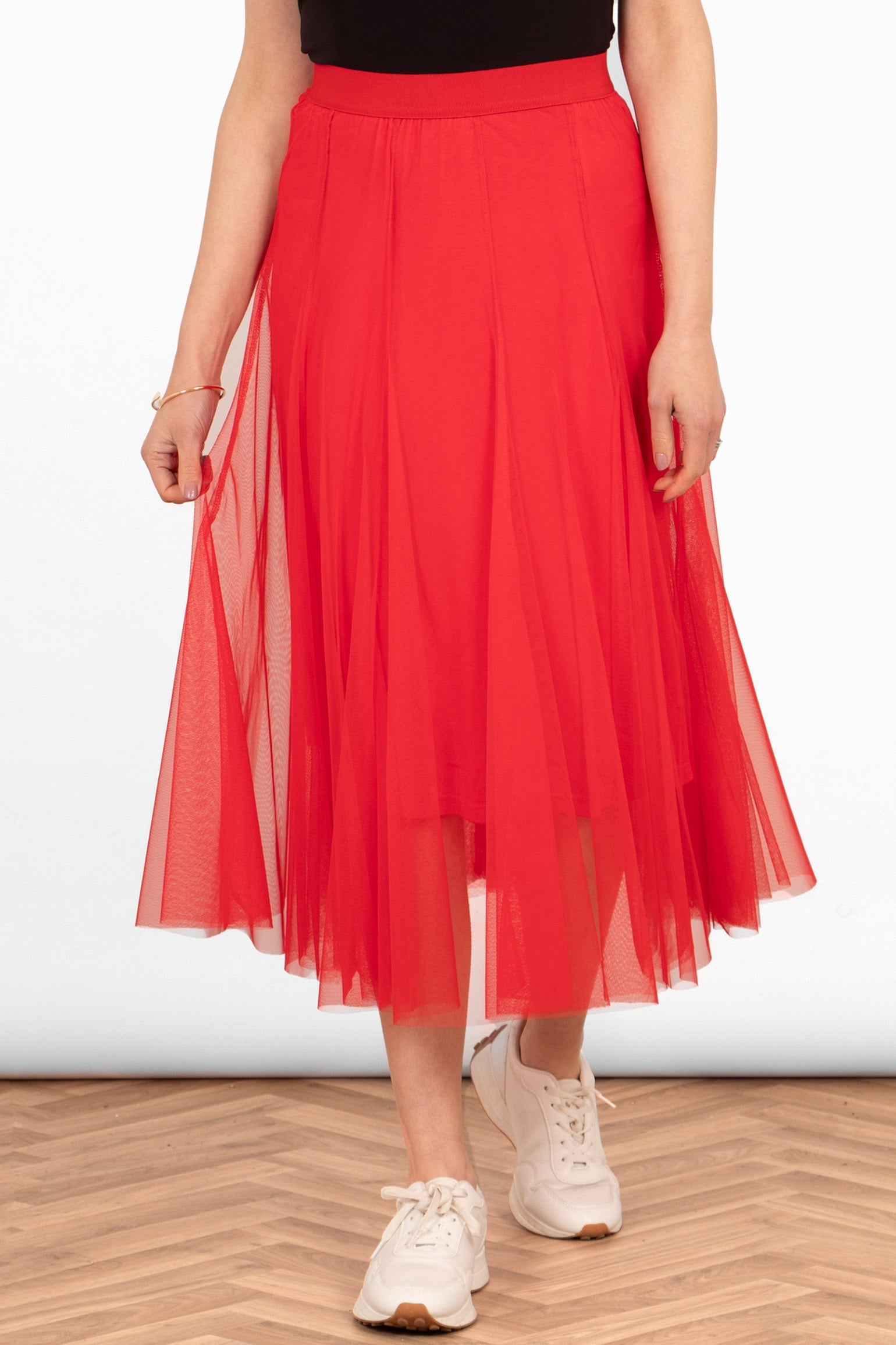 model wearing a plain red layered tulle midi skirt with a matching red underskirt and elasticated waistband