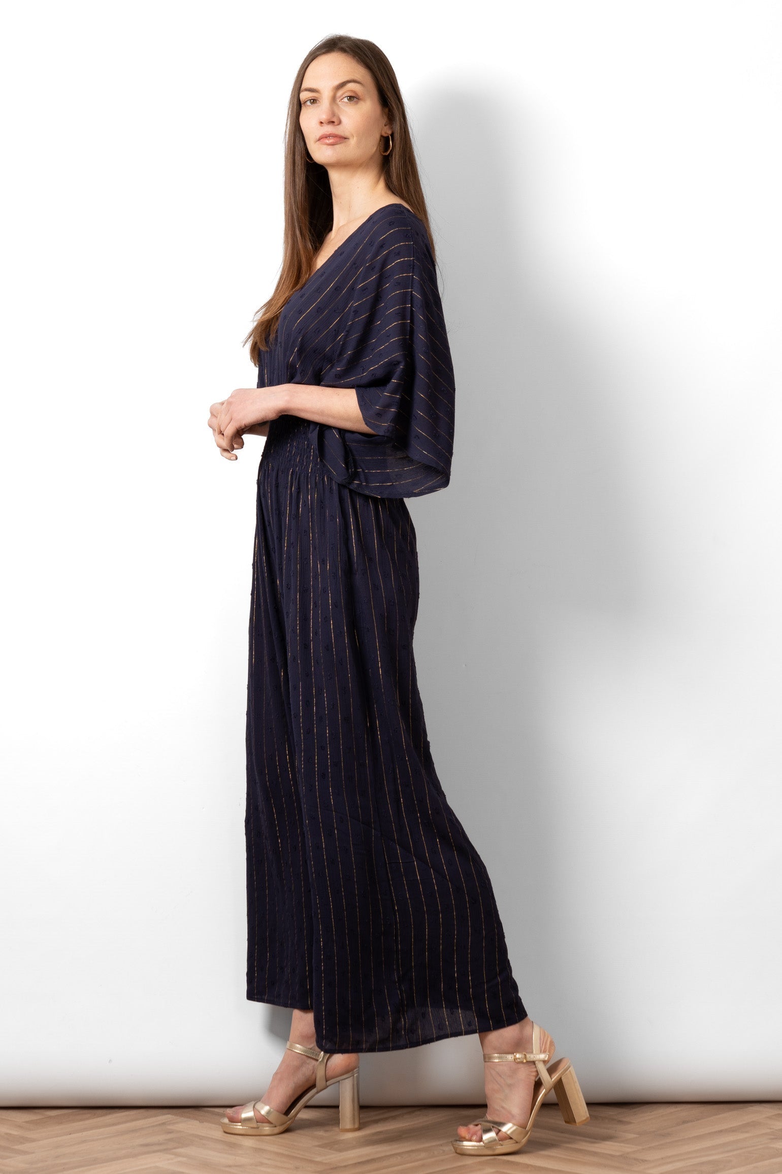 lyra-deep-v-neck-jumpsuit-navy-blue-metallic-stripe-side-view-wide-leg