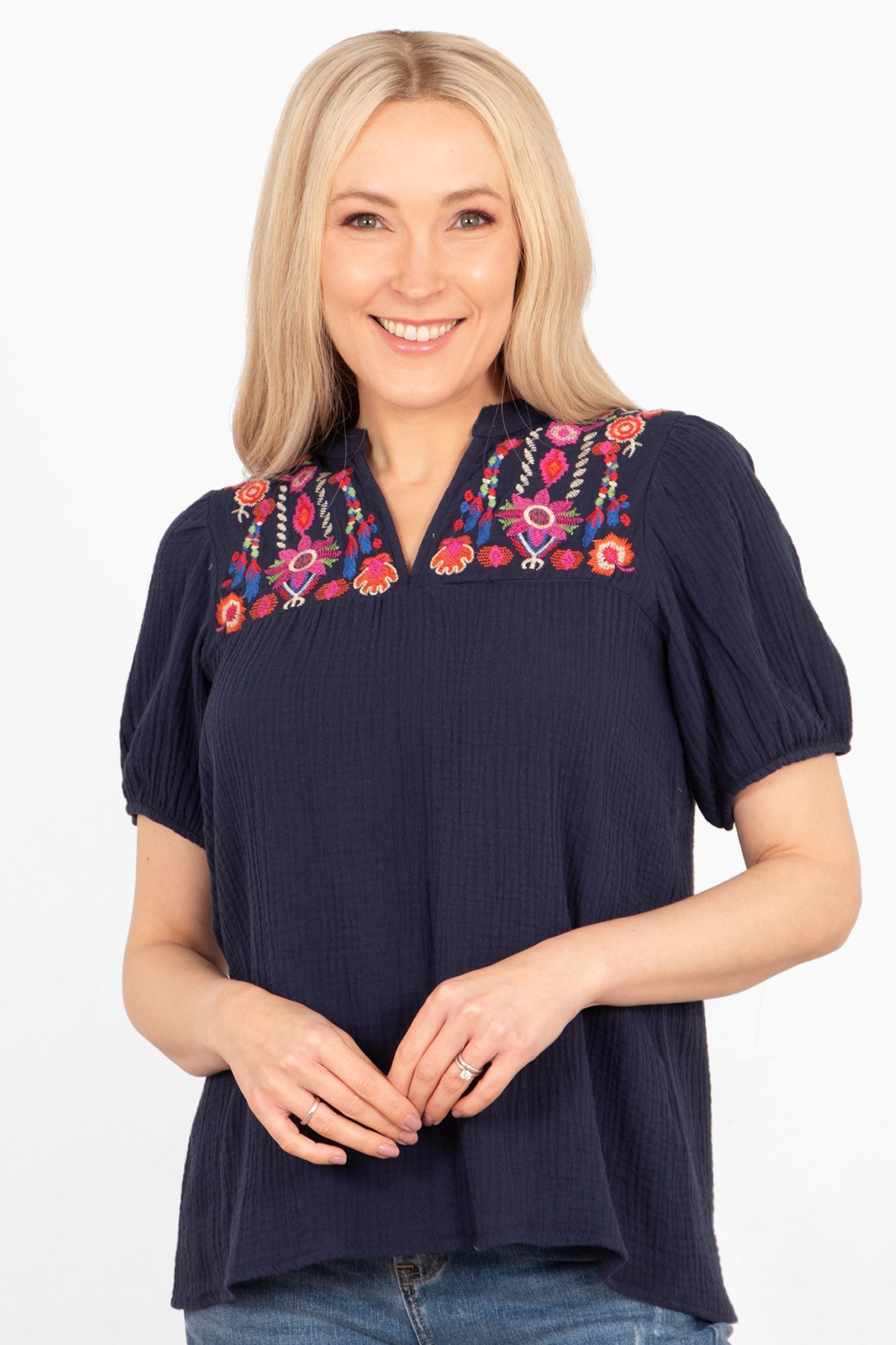 lula-short-sleeve-blouse-navy-blue-floral-embroidery-on-model-front-view-colourful-flowers-lapel