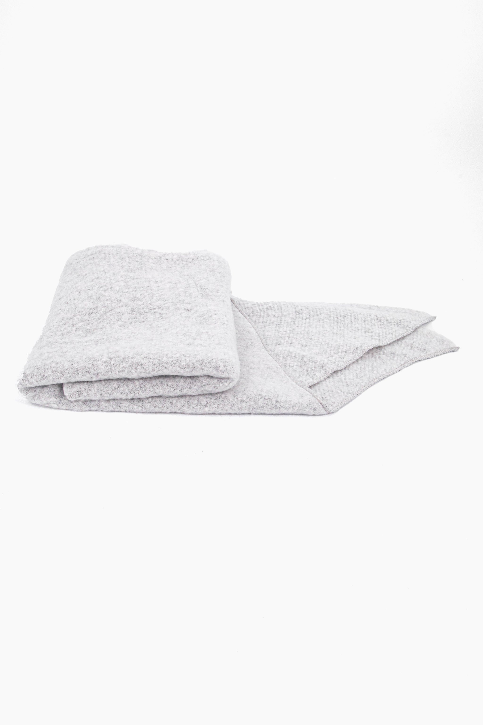 close up of the scarf folded on a flat surface, showing the soft textured fabric