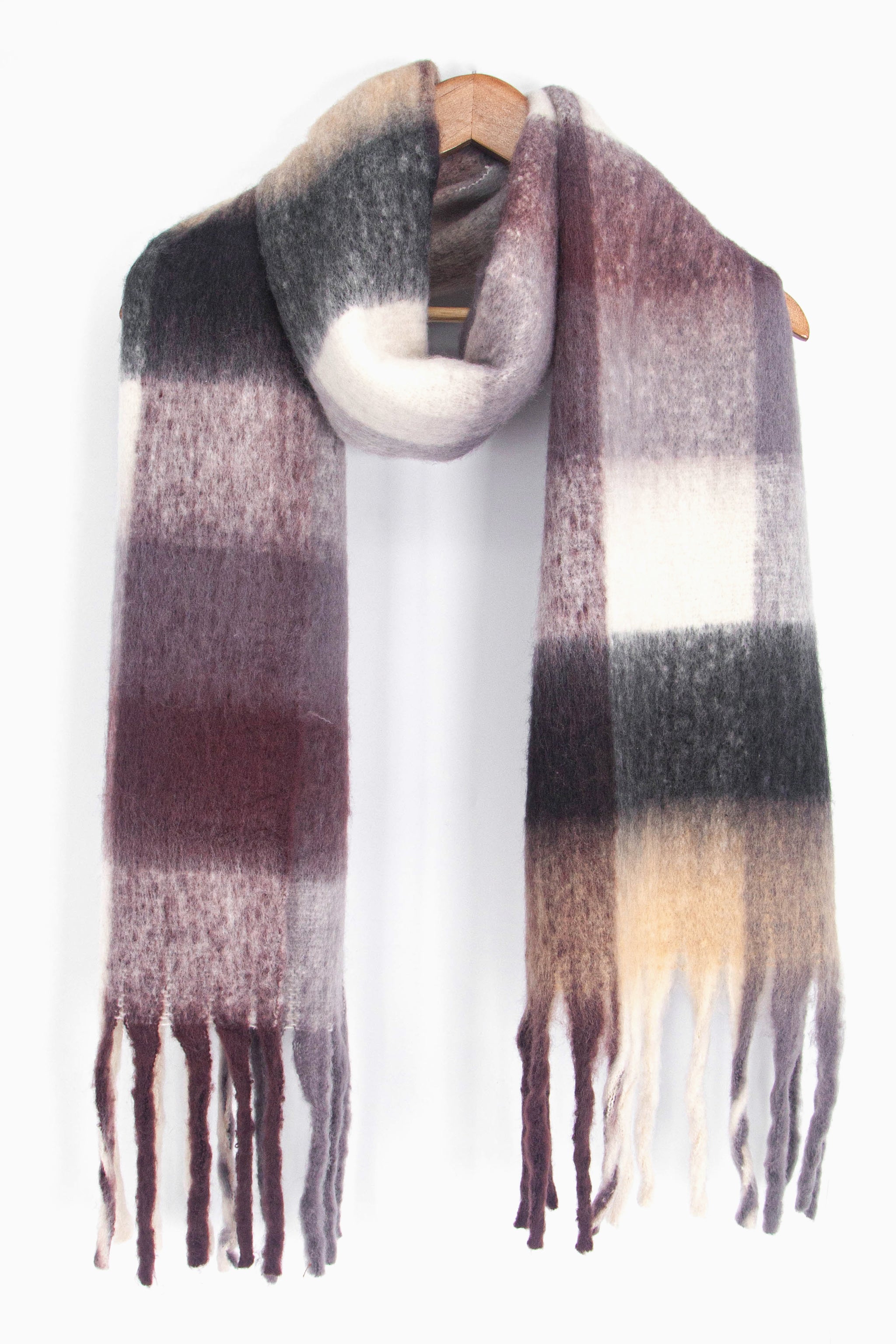 showing the black and brown square colour block winter scarf draped around a coat hanger