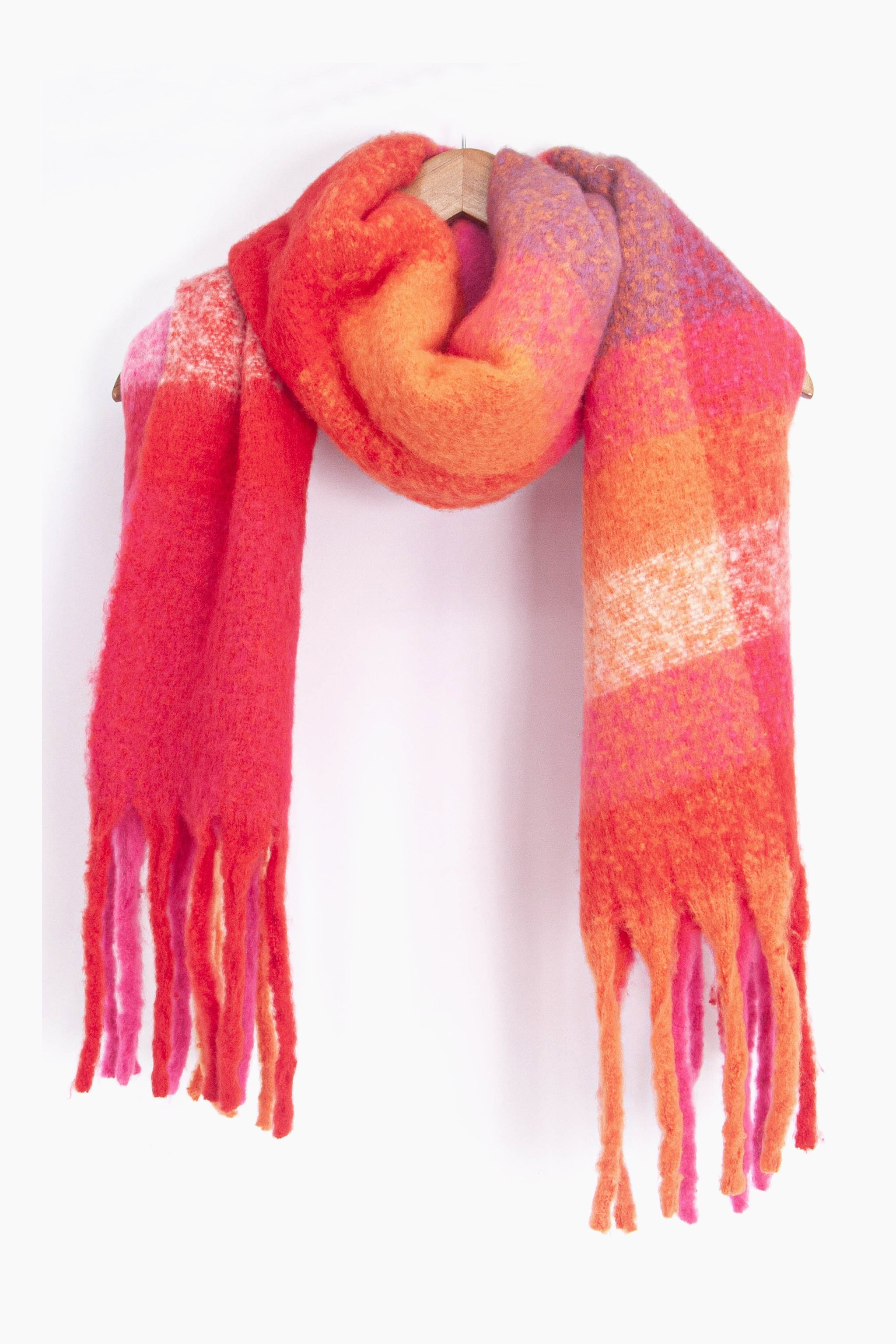 showing the multicoloured square colour block winter scarf draped around a coat hanger, showing how it would look when worn.