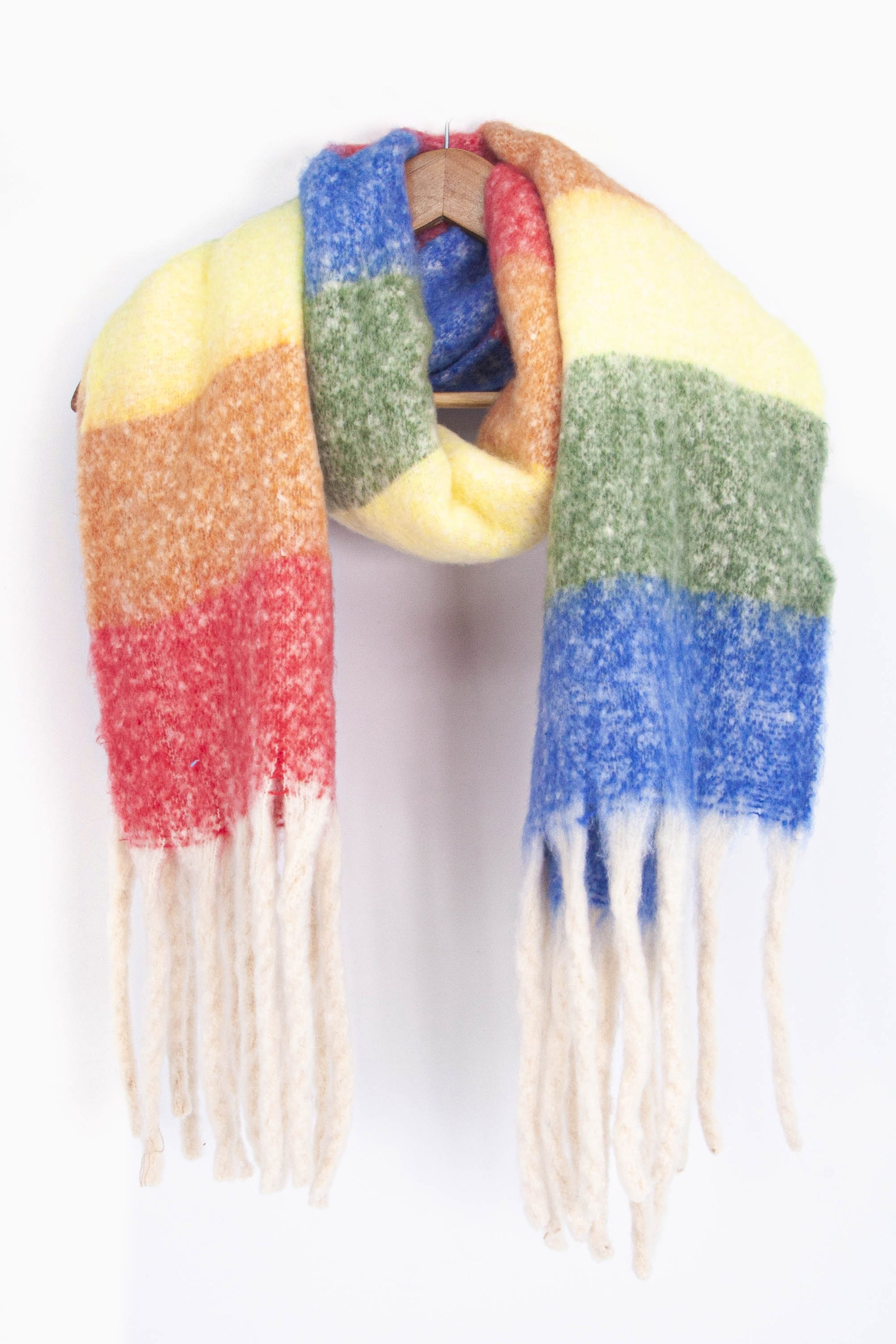 showing the multicoloured horizontal rainbow stripe winter scarf draped around a coat hanger, showing how it would look when worn.