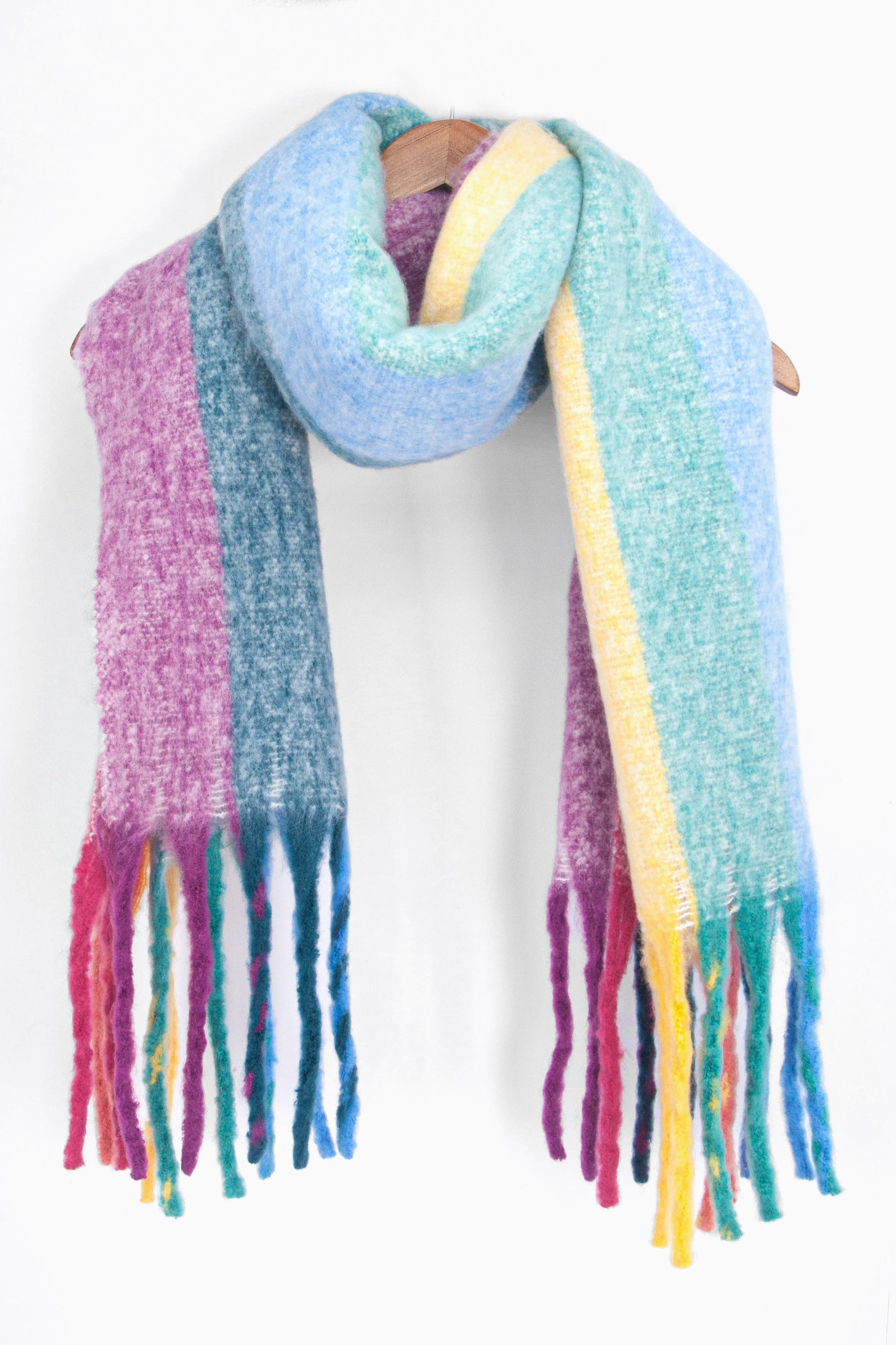 showing the multicoloured rainbow stripe winter scarf draped around a coat hanger, showing how it would look when worn.