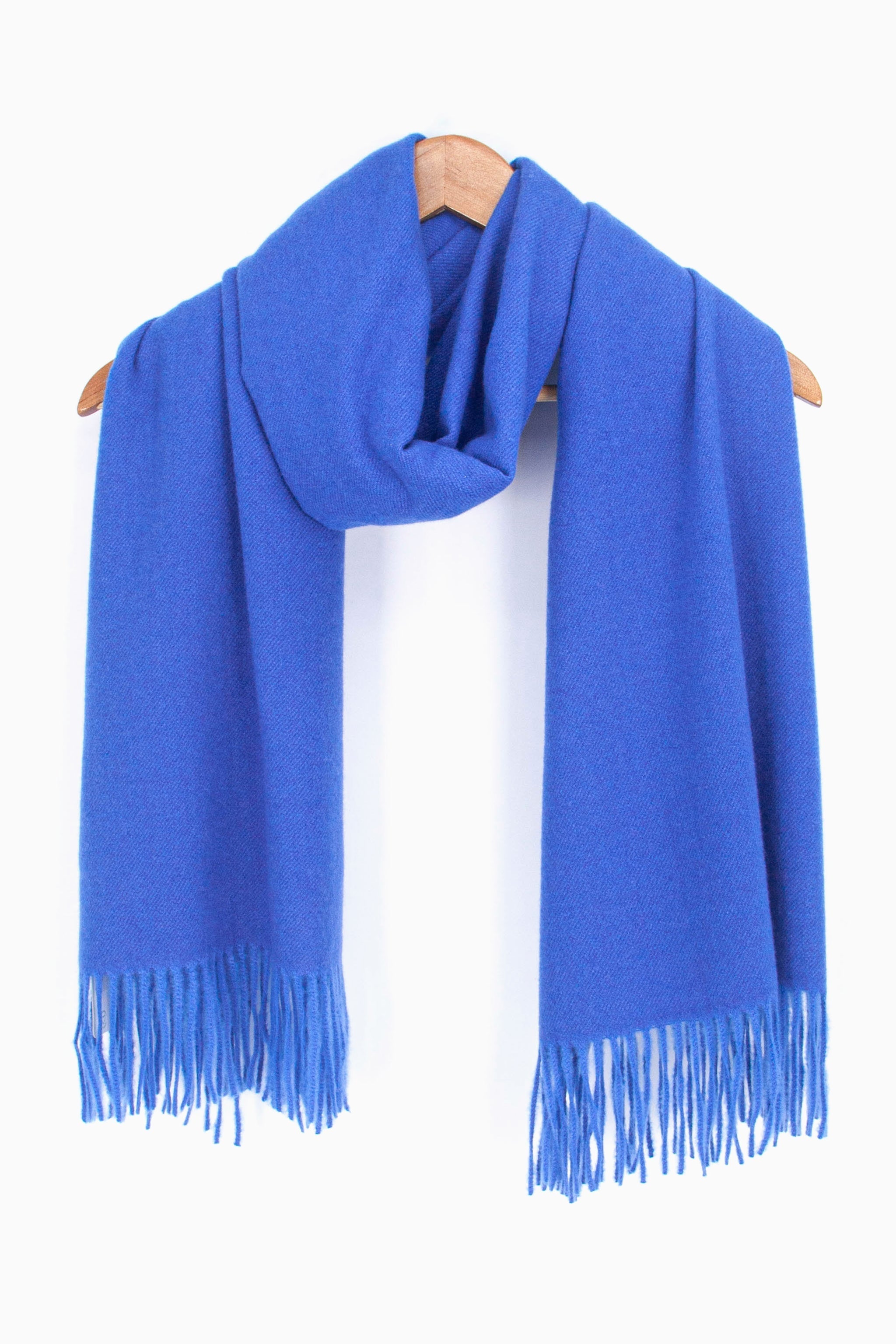 showing the plain royal blue winter scarf draped around a coat hanger