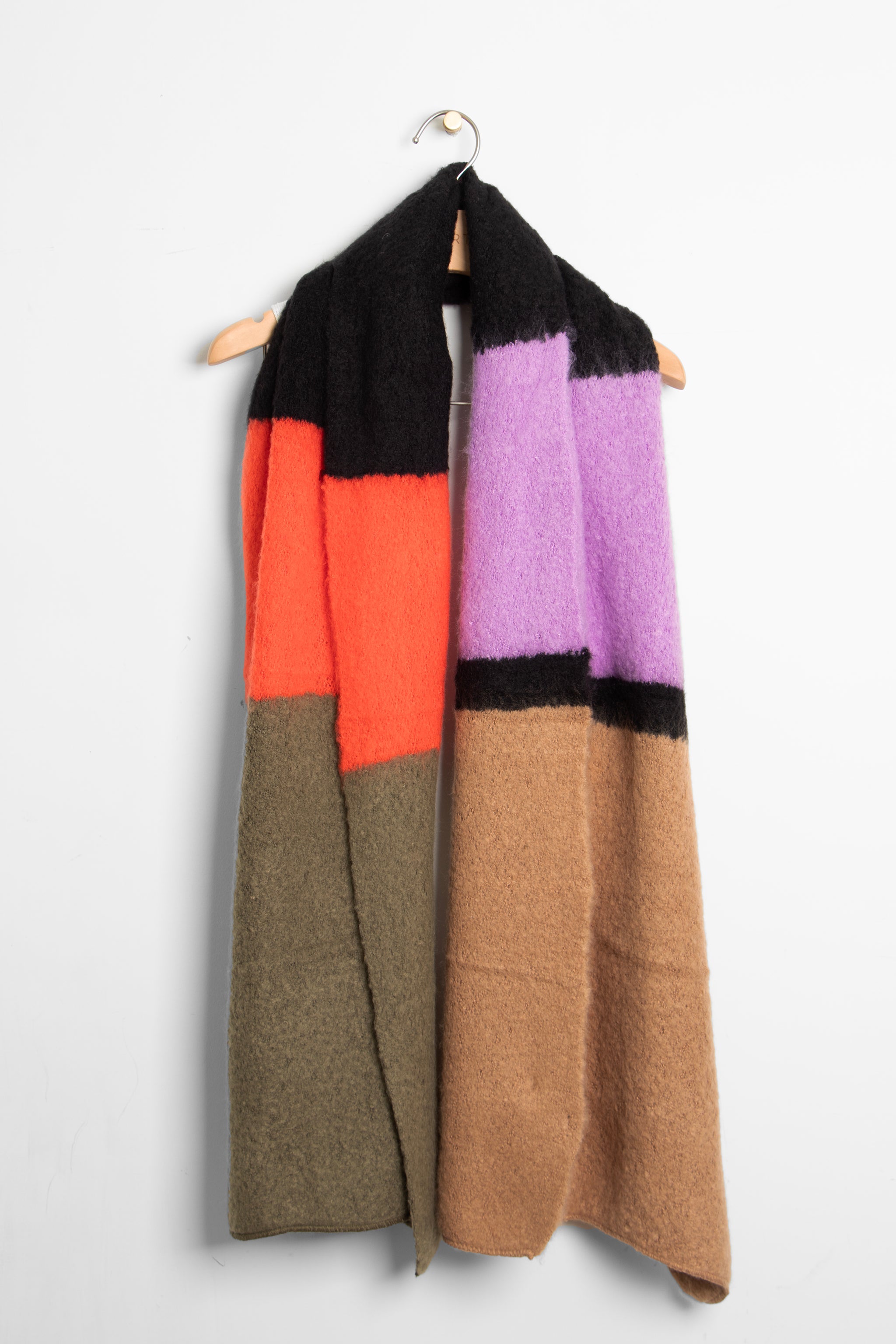 showing the multicoloured colour block winter scarf draped around a coat hanger, showing how it would look when worn.