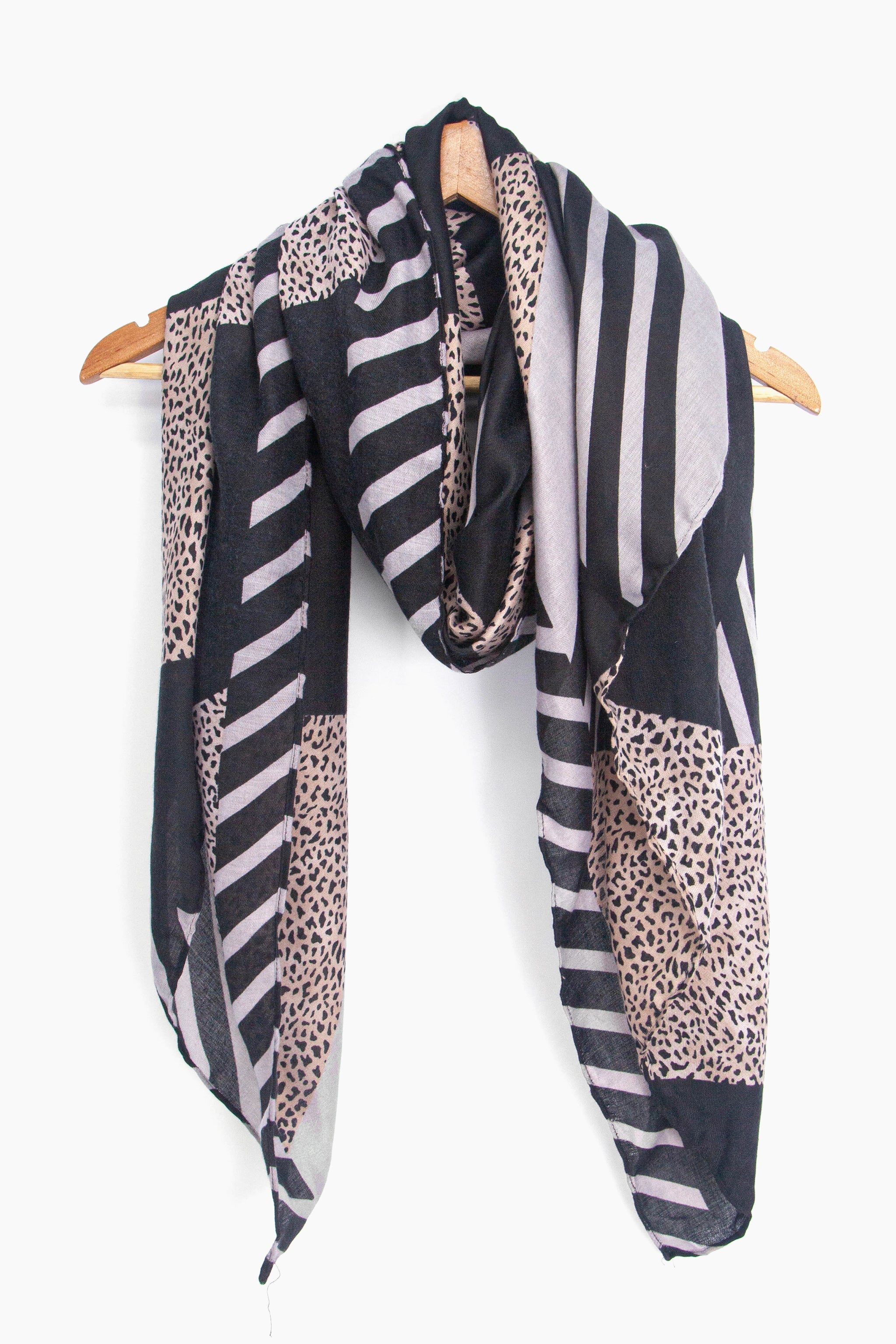 showing the scarf draped around a coat hanger, showing the all over pattern and how it would look when worn