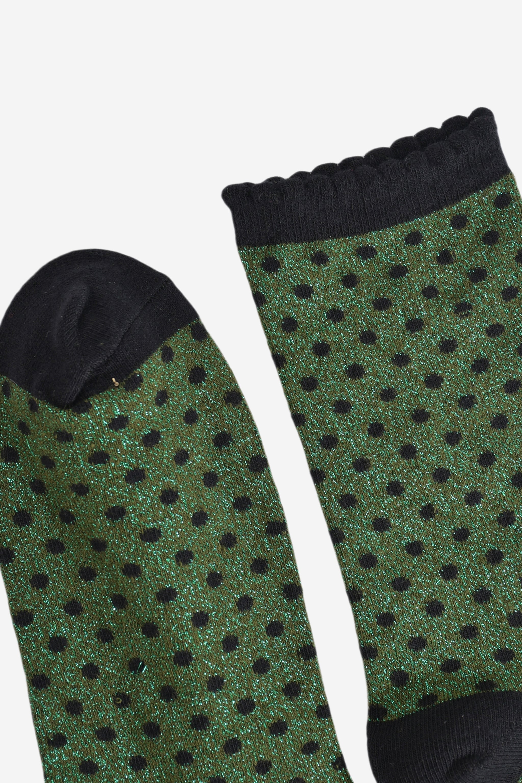 close up of the cuff and toe of the socks, they are both black and the cuff is scalloped