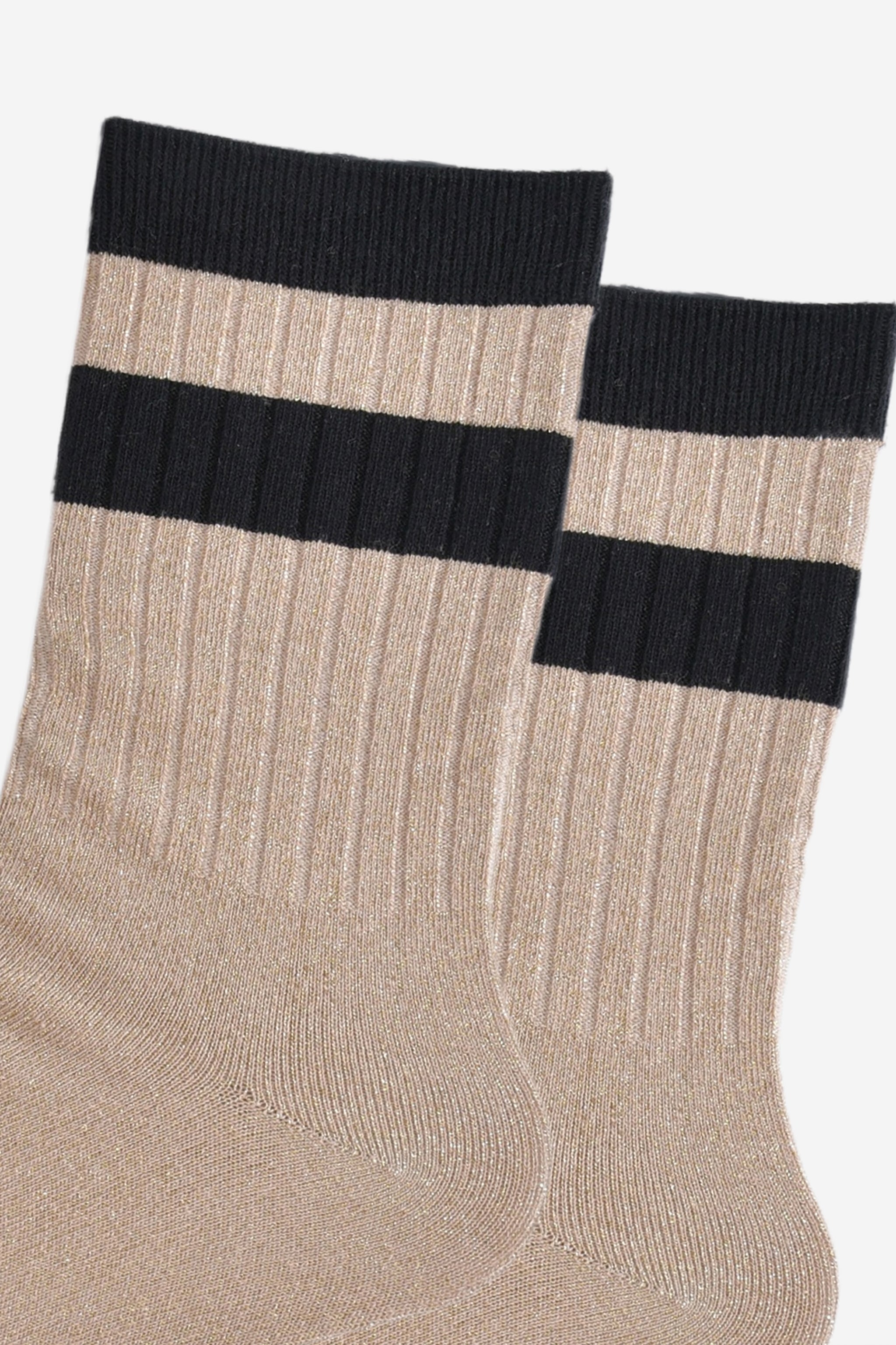 close up of the ribbed sports style cuffs on the socks. they have vertical ribbed details. the base of the socks are gold with a glitter sparkle. the cuff is black and there is a horizontal black band stripe, without glitter an inch below the cuff. 