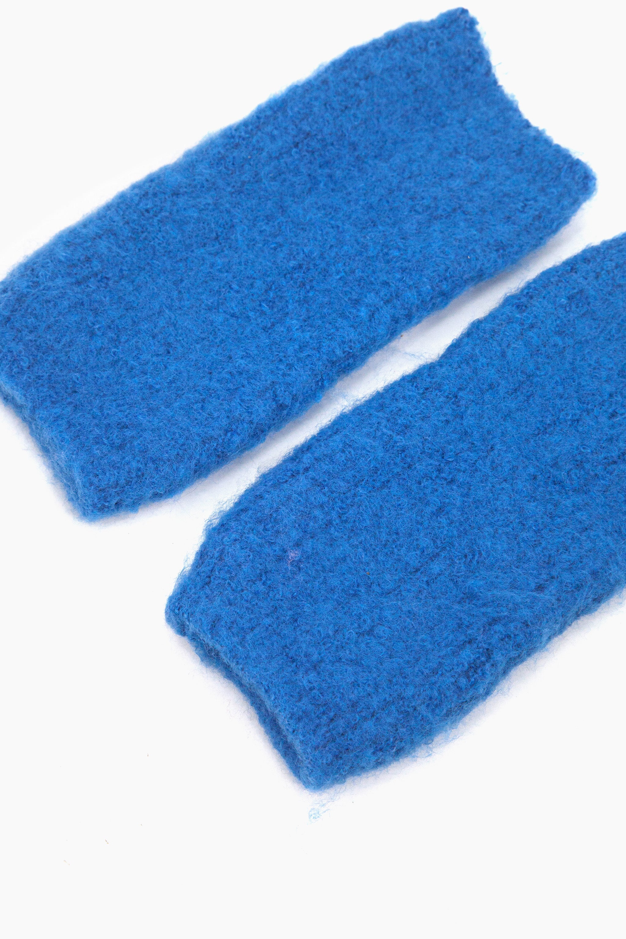 side view of the knitted wrist warmers, showing the opening at each end