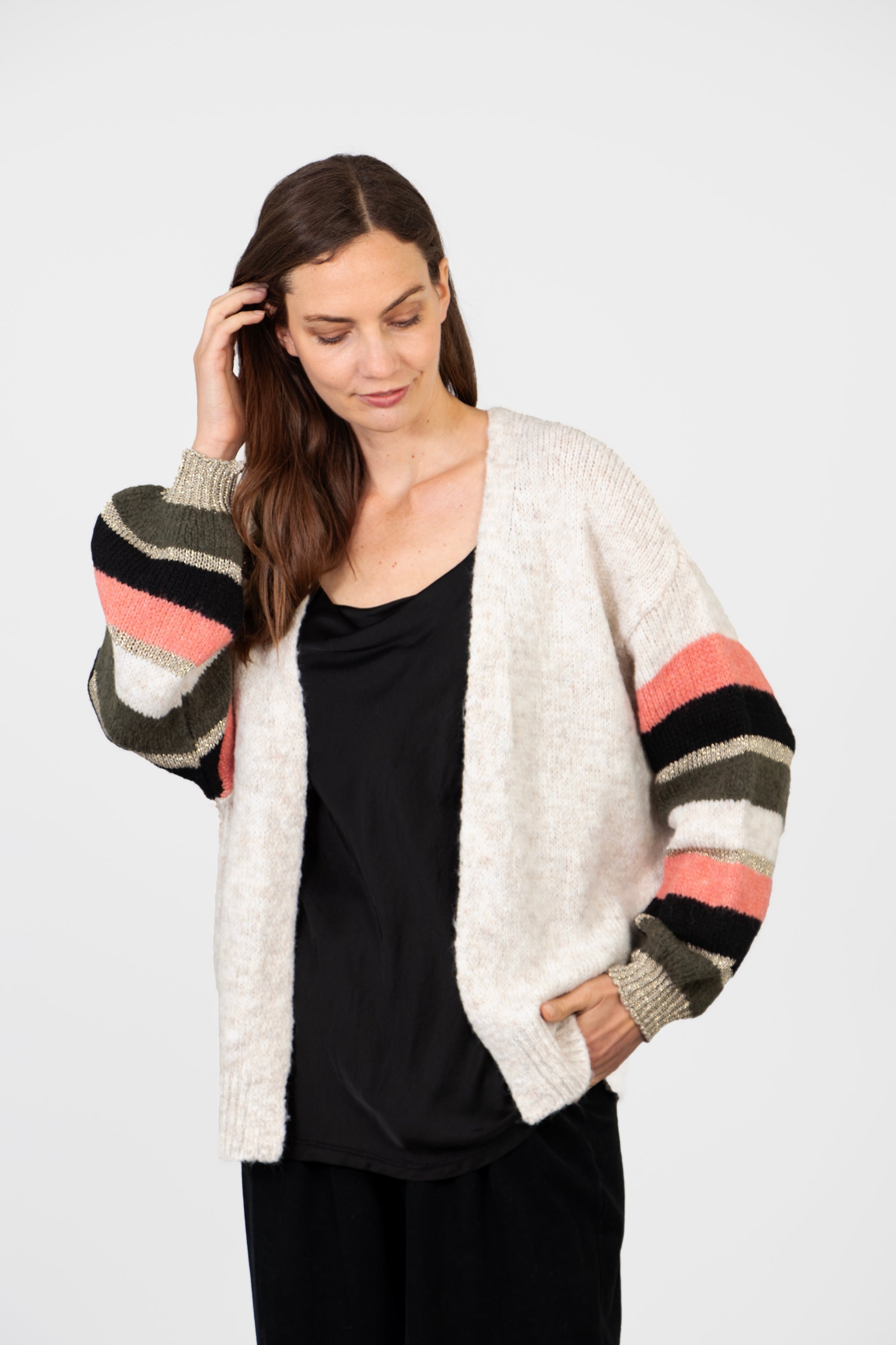 model wearing a relaxed fitting striped balloon sleeve cardigan with an open front