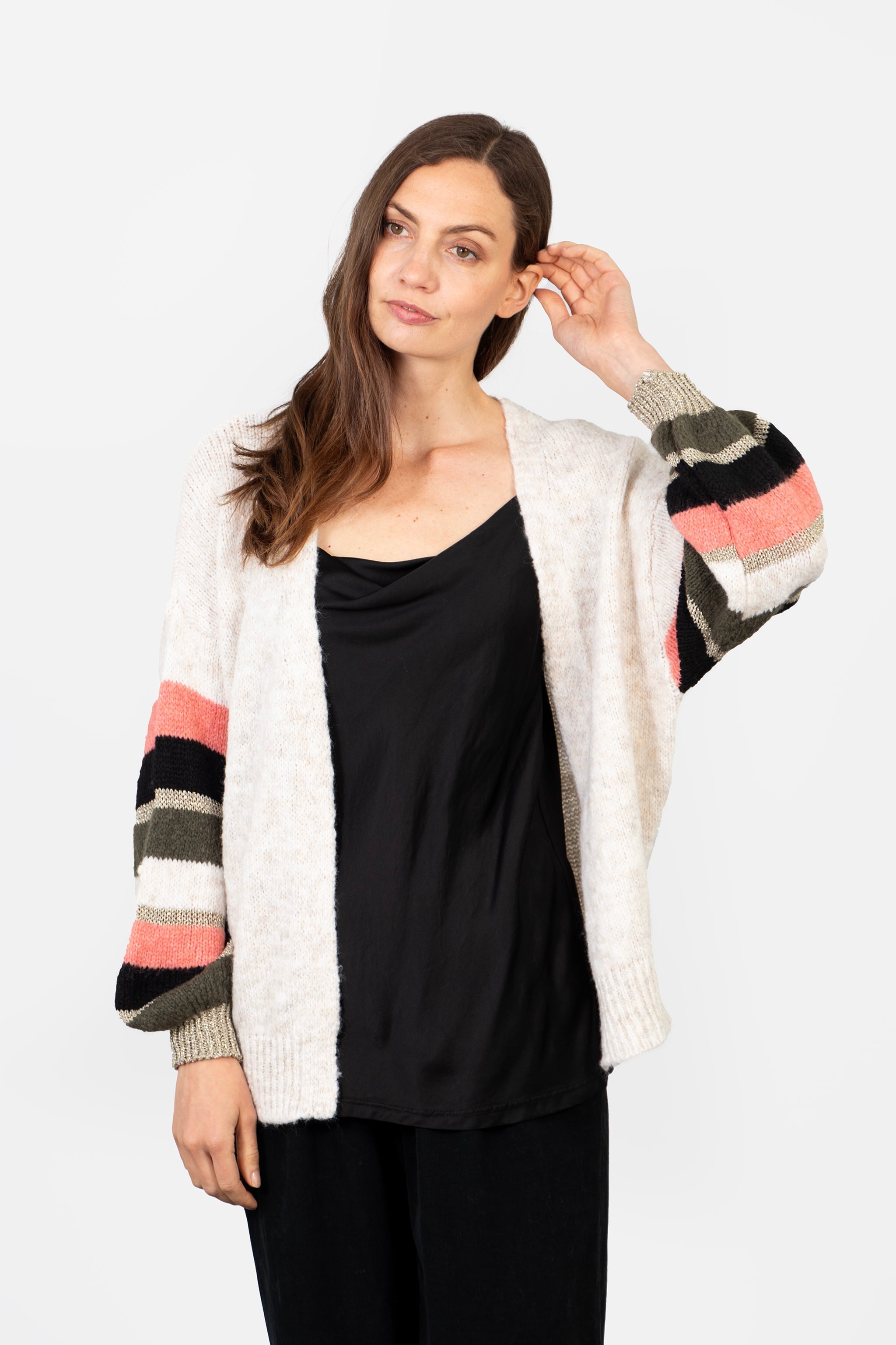 model showing the loose fitting design of the cream striped balloon sleeve cardigan