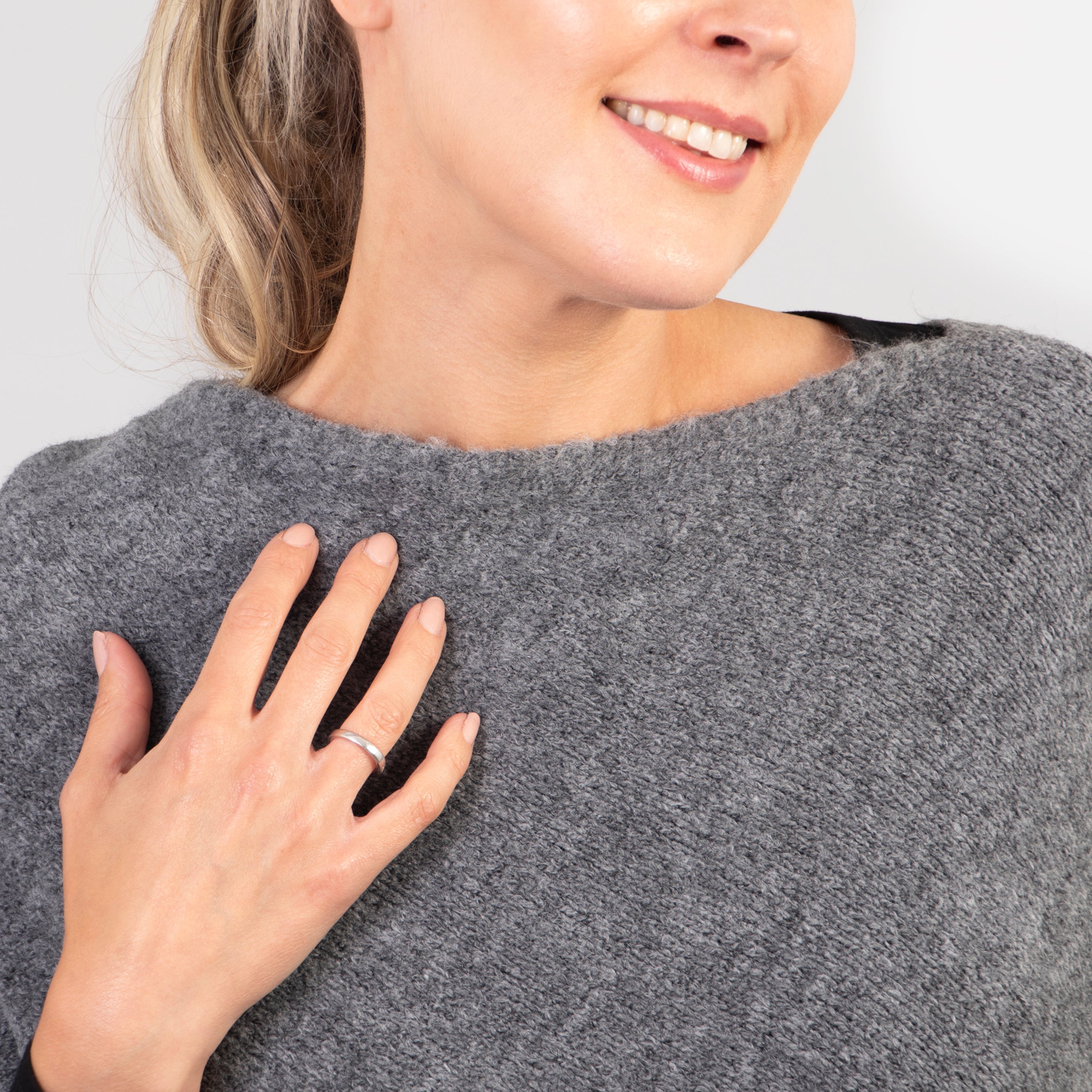 close up of the cowl neck on the grey poncho sweater