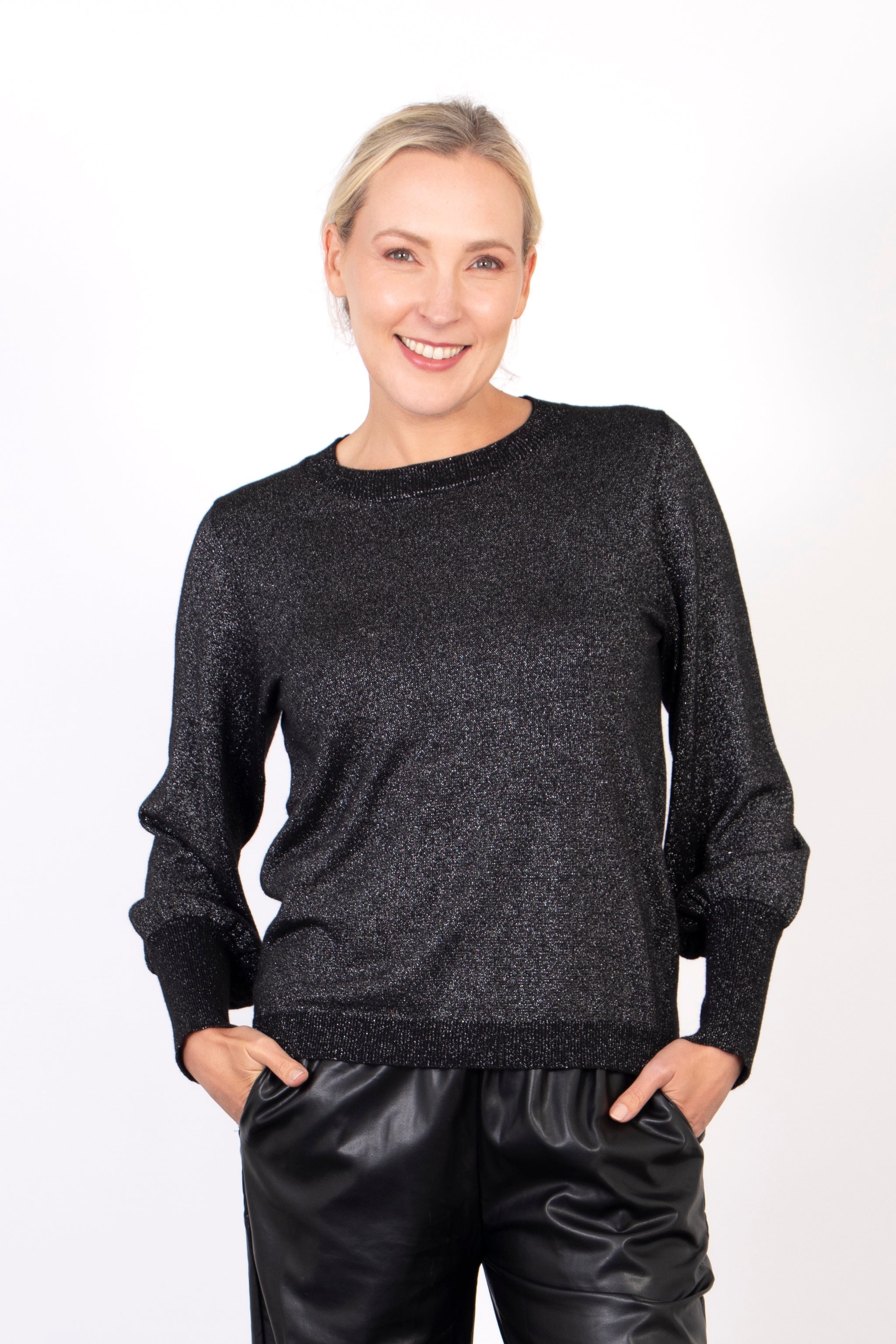 model wearing a black and silver glitter balloon sleeve jumper with a round neck