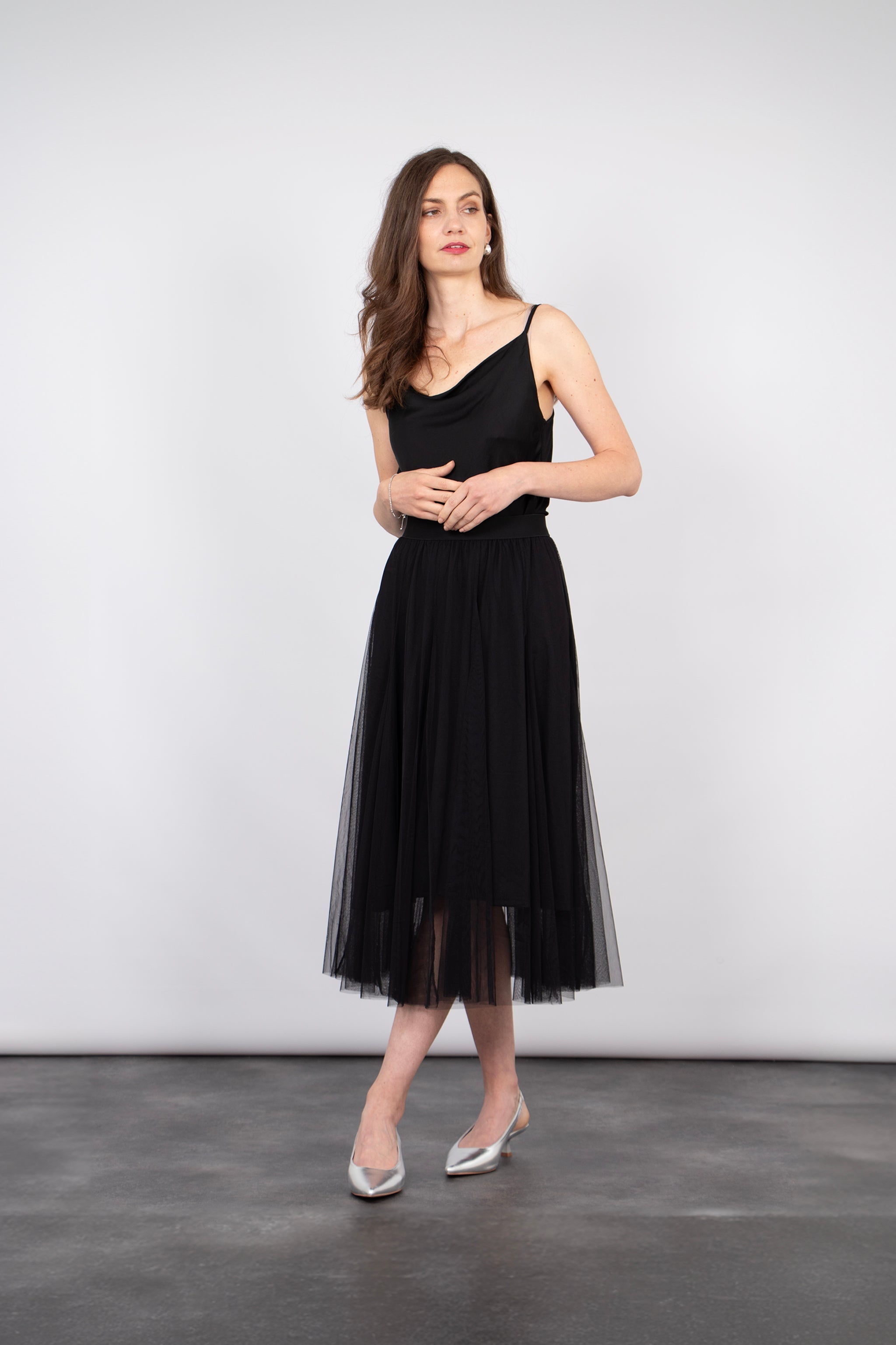 model wearing a black midi length ruffled tulle skirt