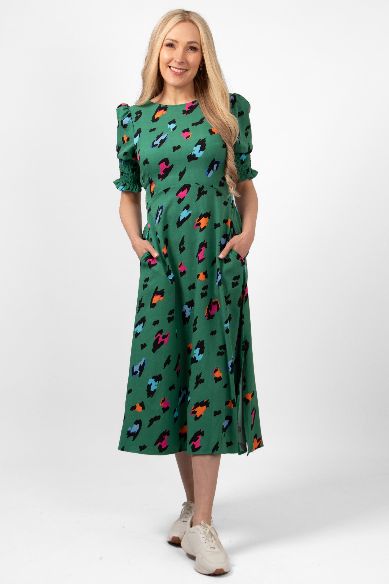 hazel-midi-tea-dress-green-large-leopard-print-on-model-front-view-side-pockets