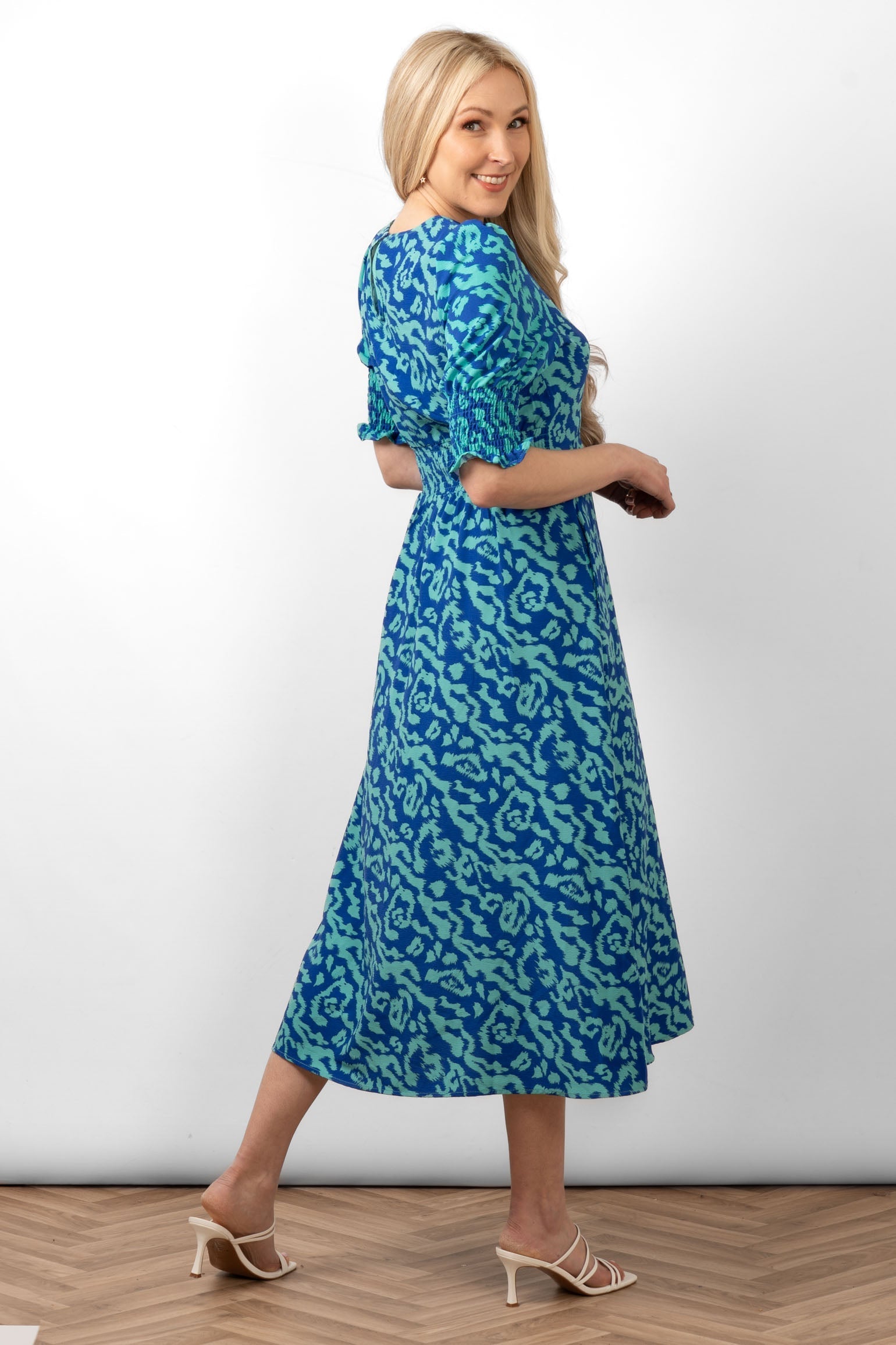 hazel-midi-tea-dress-blue-animal-print-side-view-shirred-puff-sleeves-two-tone-blue-pattern