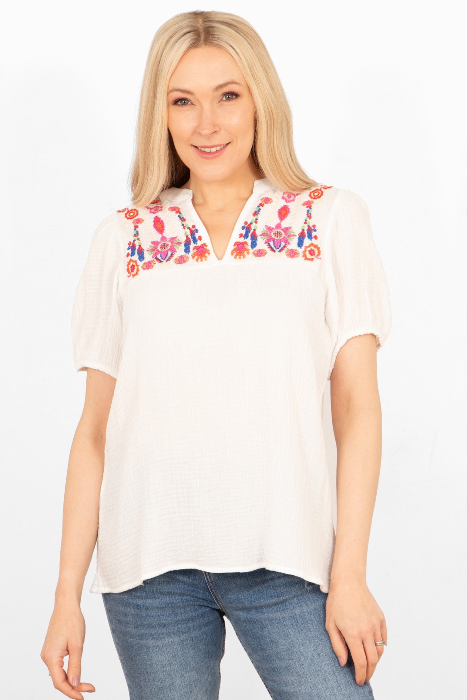 lula-short-sleeve-blouse-white-floral-embroidery-worn-on-model-colourful-flowers-lapel