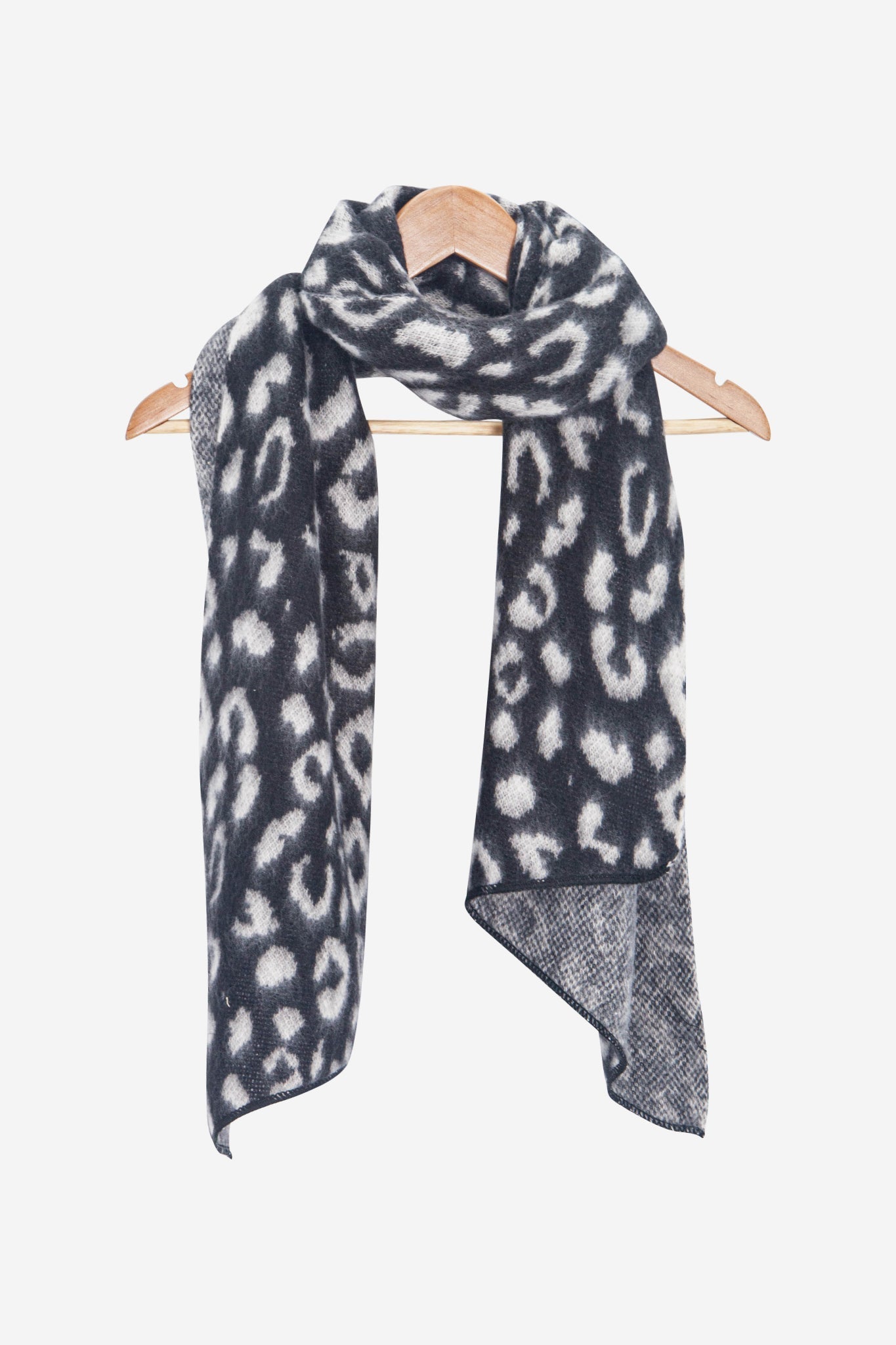 nico-black-white-leopard-heavyweight-scarf-draped-on-coat-hanger